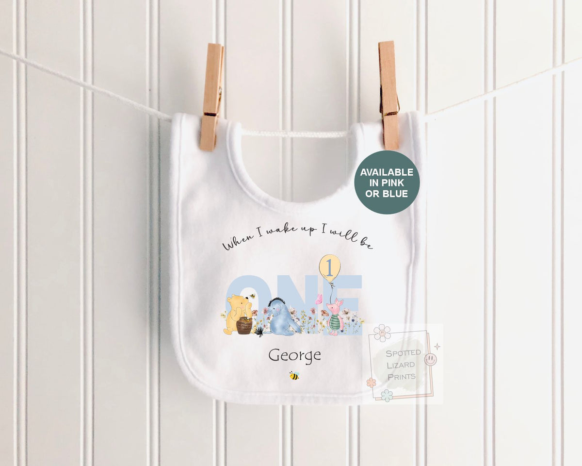 Personalised 1st birthday baby outfit available in pink or blue. Add their name and choose a first birthday bib, baby vest or sleepsuit for their special day.