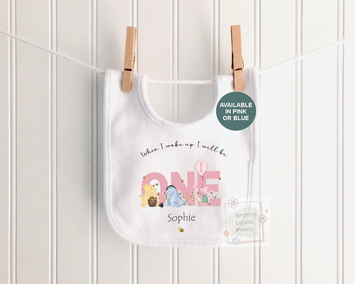 Personalised 1st birthday baby outfit available in pink or blue. Add their name and choose a first birthday bib, baby vest or sleepsuit for their special day.