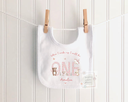 Personalised 1st birthday girl outfit with floral ONE and cute woodland animals. Add her name and choose a personalised bib, baby vest or sleepsuit.