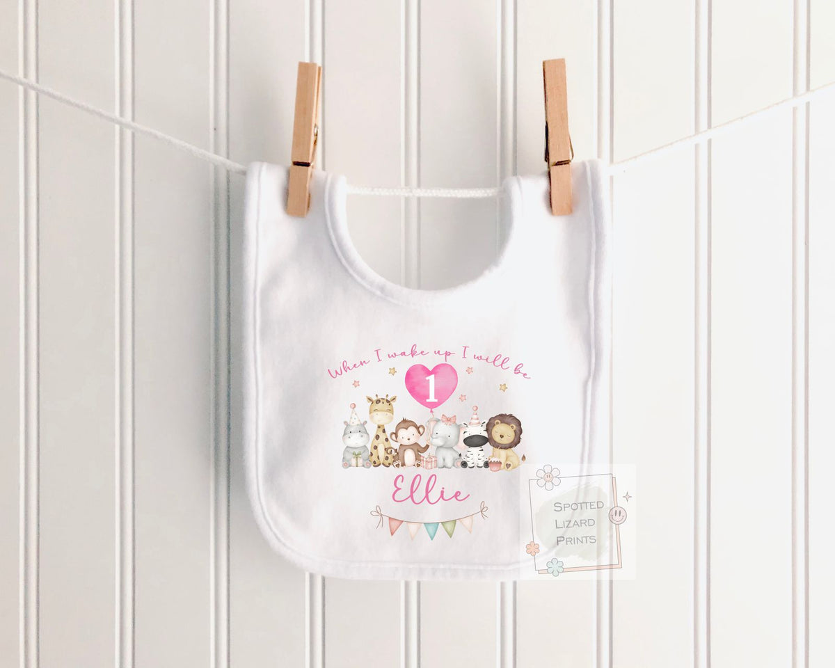 Personalised 1st birthday girl outfit with cute safari animals and custom name. Choose a baby bib, vest or sleepsuit for her special first birthday.