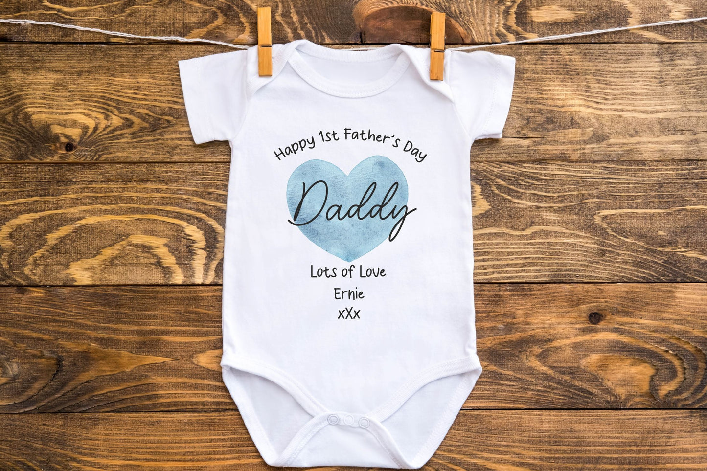 our first fathers day baby vest with blue heart