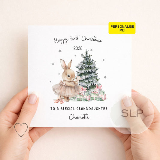Personalised first Christmas card for a baby girl, granddaughter or daughter. Featuring a cute Christmas bunny, tree and gifts. Add your own wording and name.
