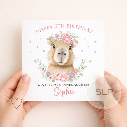 Cute personalised capybara birthday card with custom name, age and relationship. A pretty floral animal card for daughters, granddaughters and capybara fans.