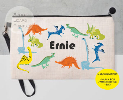 White pencil case. Dinosaur themed. Personalised with a name.