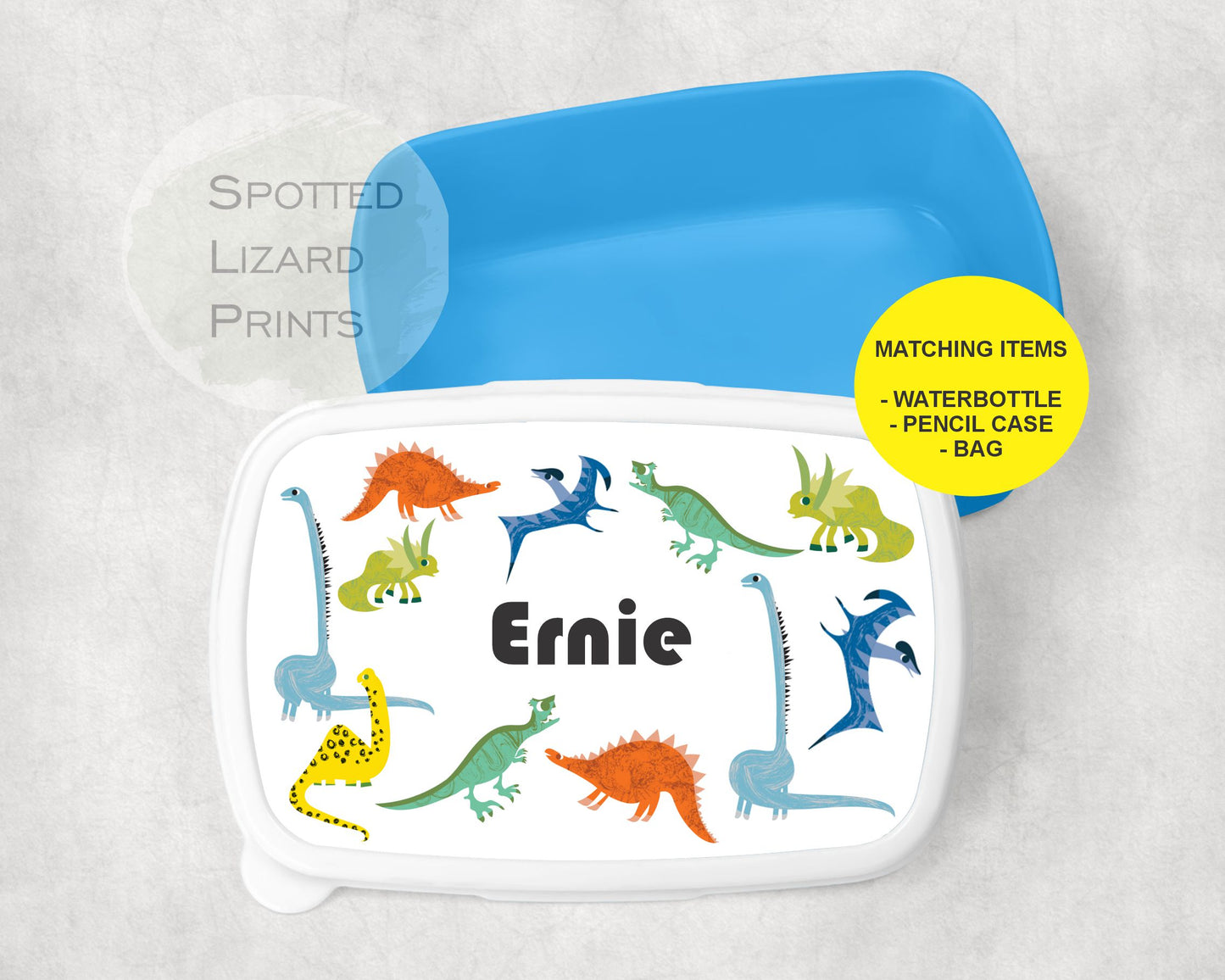 Blue lunch box. Dinosaur themed. Personalised with a name.