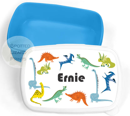 Blue lunch box. Dinosaur themed. Personalised with a name.