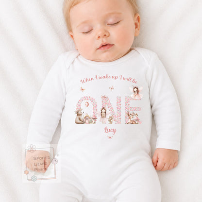 Personalised 1st birthday girl outfit with fairies, woodland animals and floral ONE design. Add her name and choose a bib, baby vest or sleepsuit.