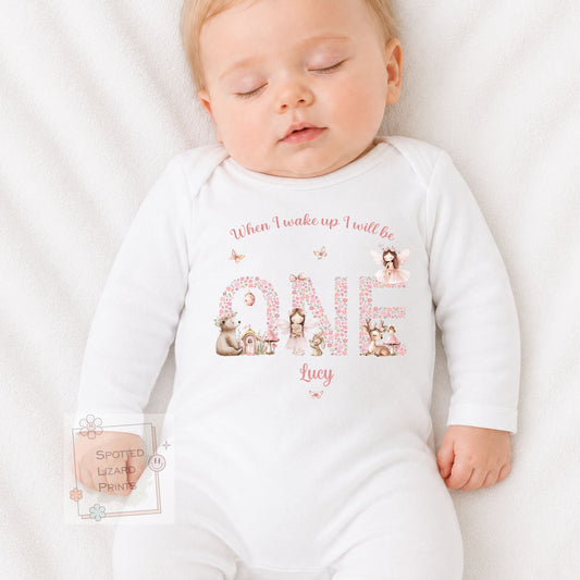 Personalised 1st birthday girl outfit with fairies, woodland animals and floral ONE design. Add her name and choose a bib, baby vest or sleepsuit.