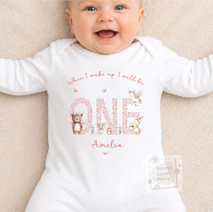 Personalised 1st birthday girl outfit with floral ONE and cute woodland animals. Add her name and choose a personalised bib, baby vest or sleepsuit.