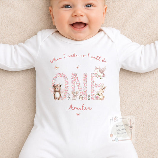 Personalised 1st birthday girl outfit with floral ONE and cute woodland animals. Add her name and choose a personalised bib, baby vest or sleepsuit.