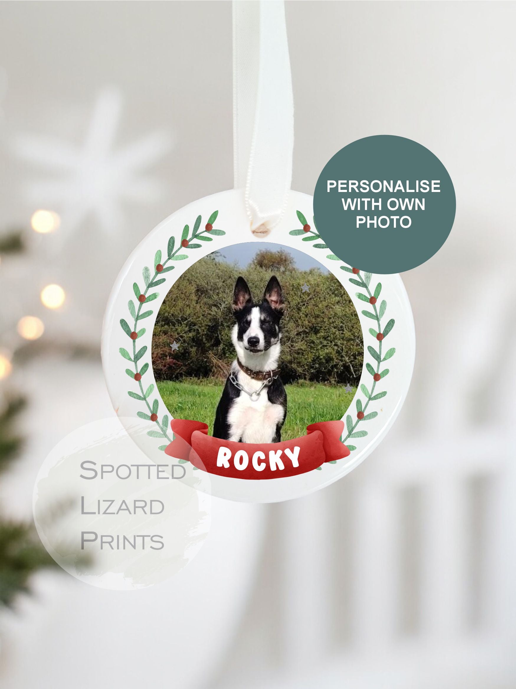 Personalised ceramic Christmas pet bauble hanging on a white ribbon
