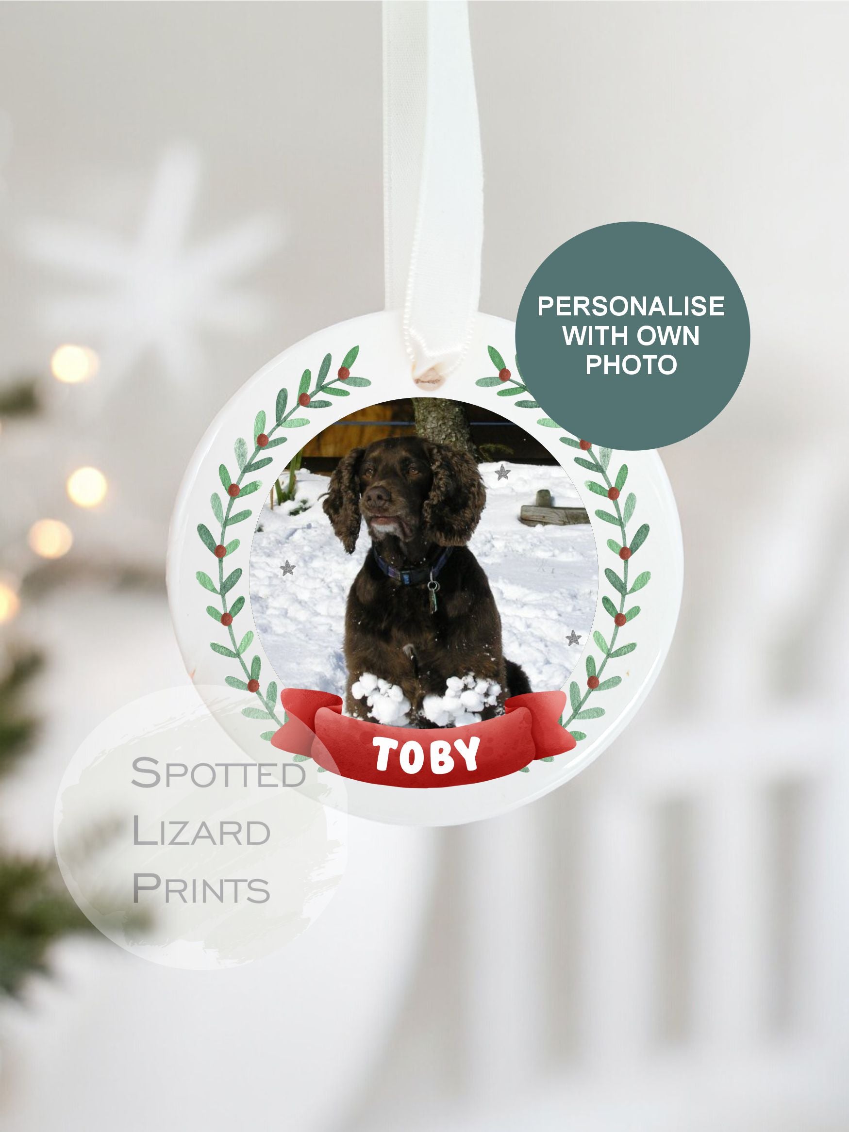 Personalised ceramic Christmas pet bauble hanging on a white ribbon